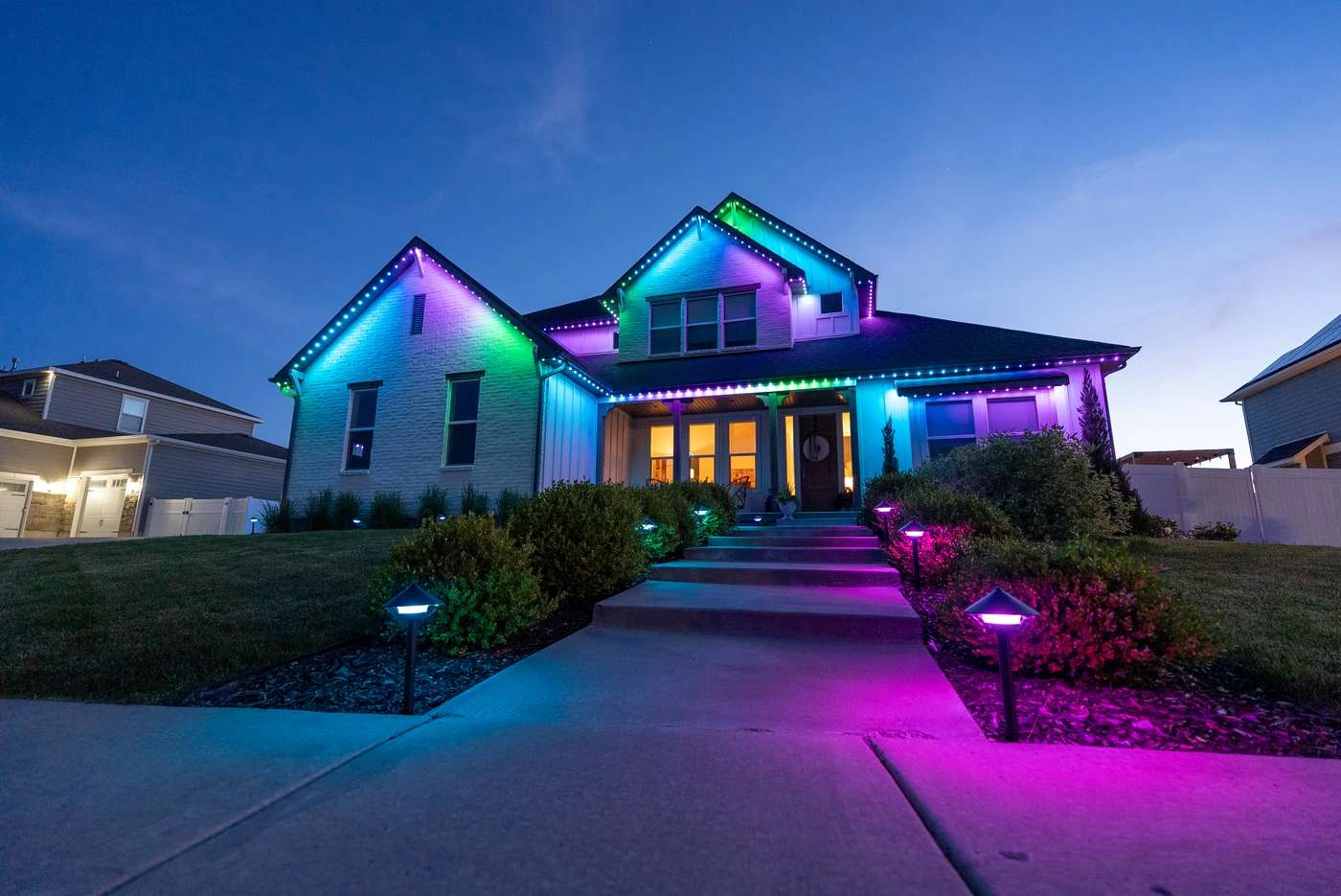 A home with colorful JellyFish permanent roofline lighting