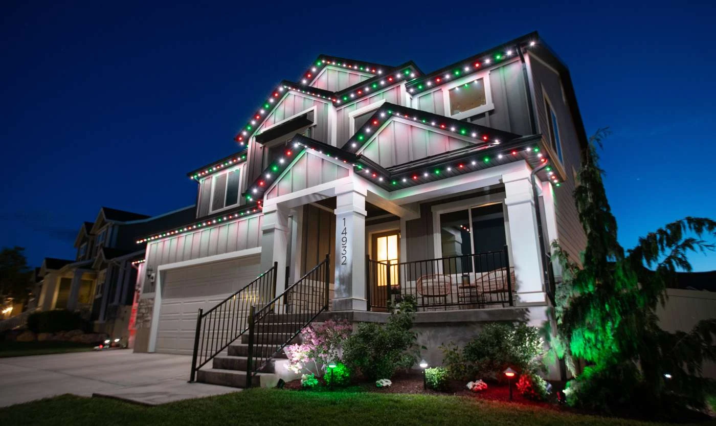 Permanent JellyFish roofline lighting set to red, green and white for the holidays