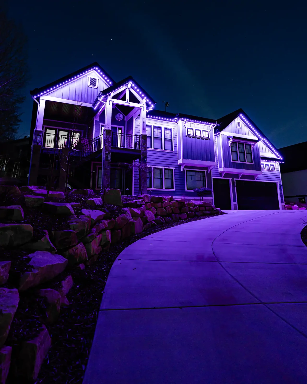 Purple permanent roofline lights on a residential home