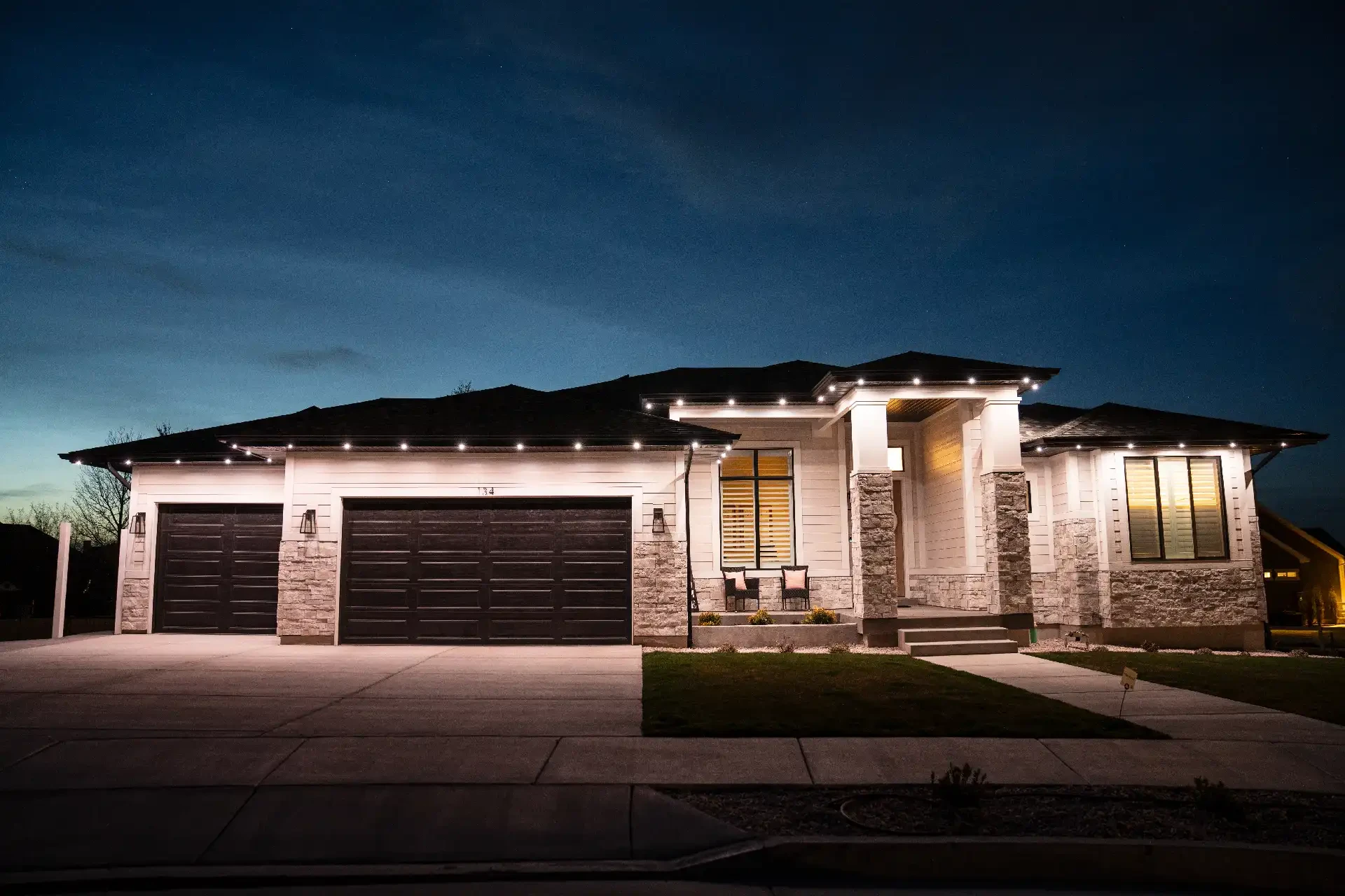 Warm white exterior roofline lighting on a home