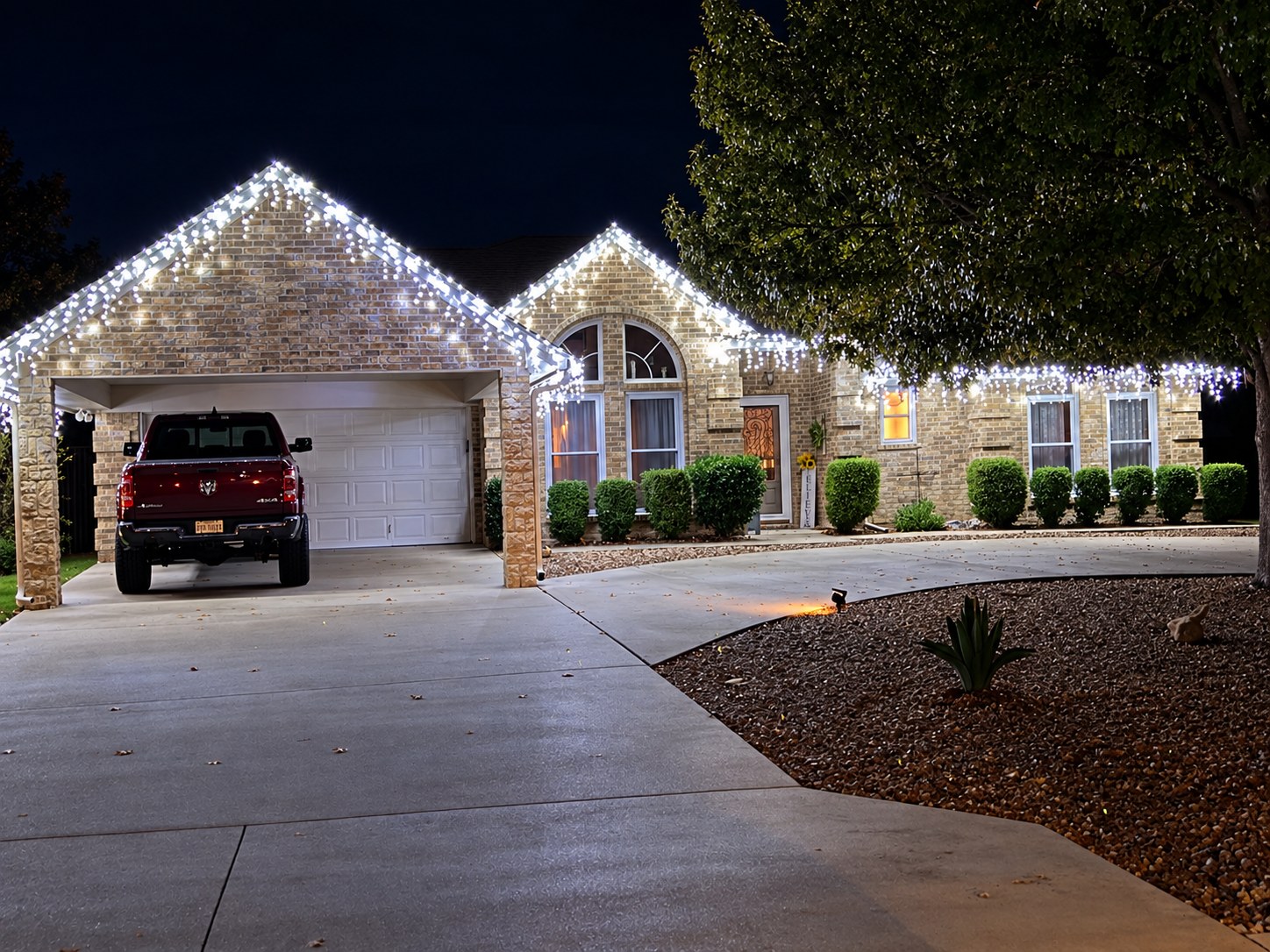 White Christmas icicle lights on a brick home
